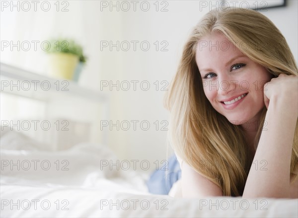 Woman relaxing on bed. 
Photo: Jamie Grill