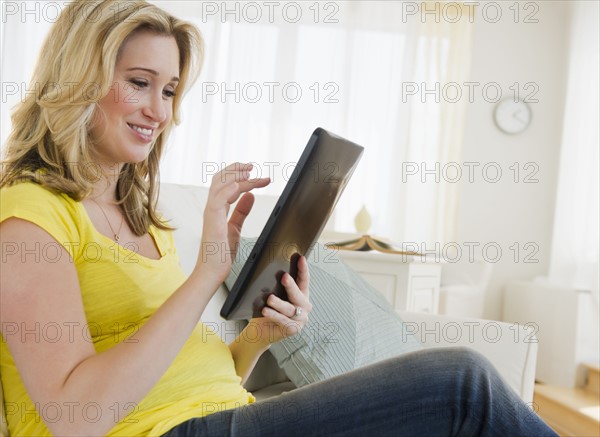 Pregnant woman using digital tablet. 
Photo: Jamie Grill