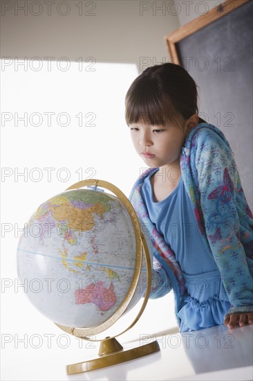 Schoolgirl (8-9) with globe. 
Photo: Rob Lewine
