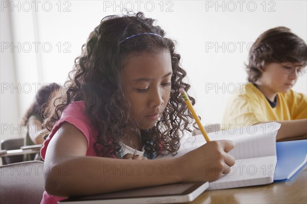 Portrait of schoolgirl (10-11) writing. 
Photo: Rob Lewine