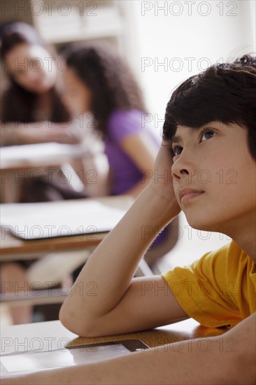 Portrait of schoolboy (12-13) contemplating. 
Photo: Rob Lewine