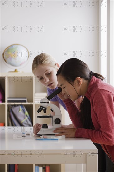 Teenage girls (14-15) working with microscope. 
Photo: Rob Lewine
