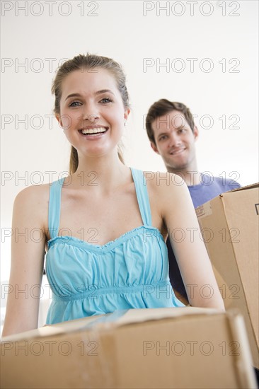 Young couple holding cardboard boxes. Photo: Jamie Grill
