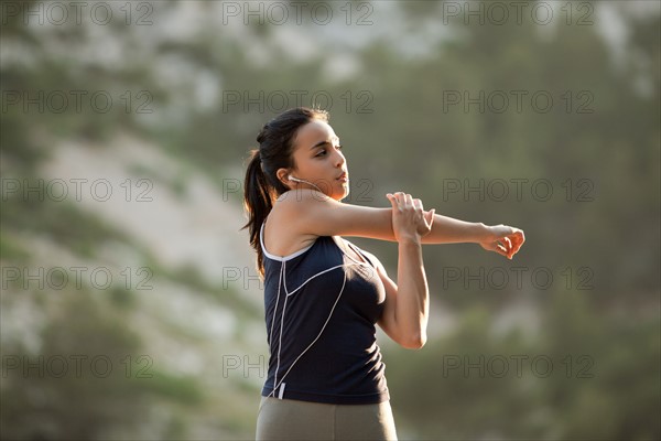 France, Marseille, Young woman stretching. Photo: Mike Kemp