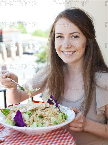 Portrait of young woman having salad. Photo: Jessica Peterson