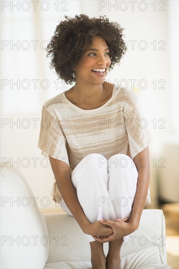 Woman sitting on sofa.