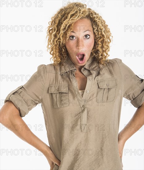 Portrait of surprised young woman, studio shot.