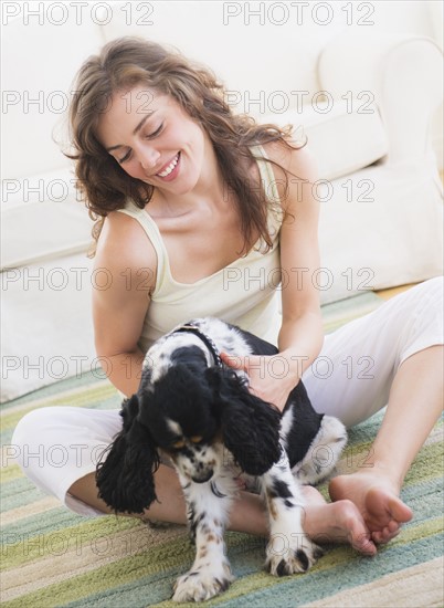 Portrait of young woman playing with dog. Photo: Daniel Grill