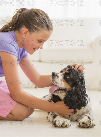 Girl (8-9) playing with her dog . Photo: Daniel Grill