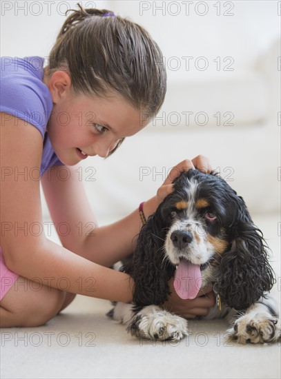 Girl (8-9) playing with her dog . Photo: Daniel Grill