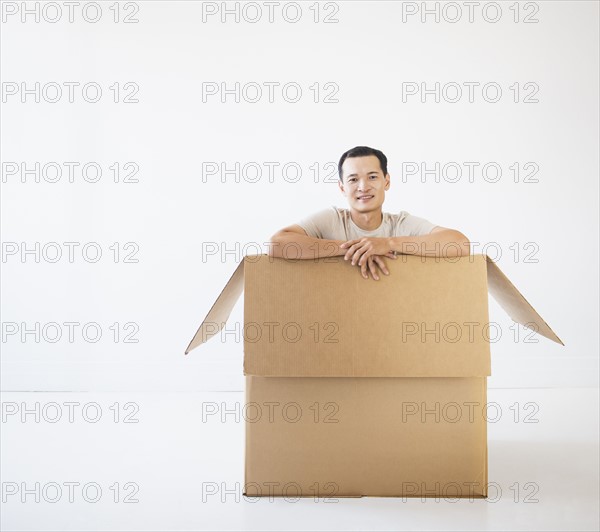 Man sitting in cardboard box. Photo: Daniel Grill