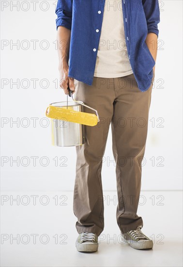 Man holding painting roll. Photo: Daniel Grill