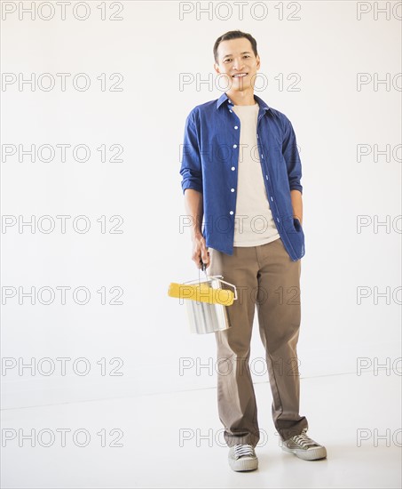 Man holding painting roll. Photo: Daniel Grill