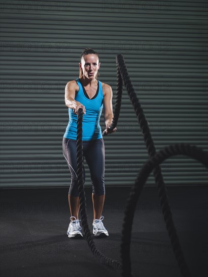 Mid adult woman exercising with rope. Photo: Erik Isakson