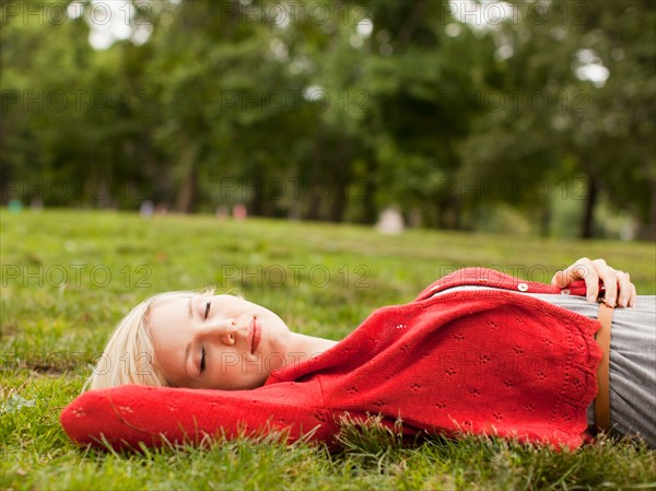 Woman laying on grass with closed eyes. Photo: Jessica Peterson