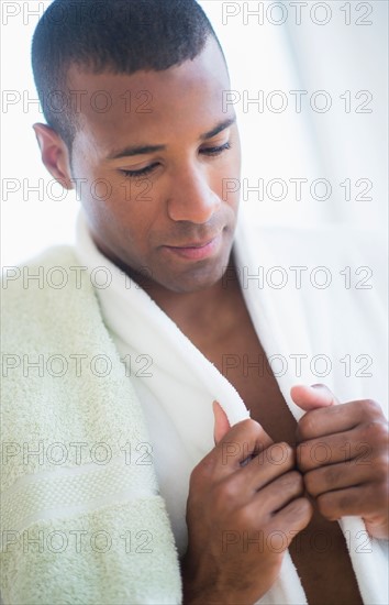 Portrait of young man in white bathrobe