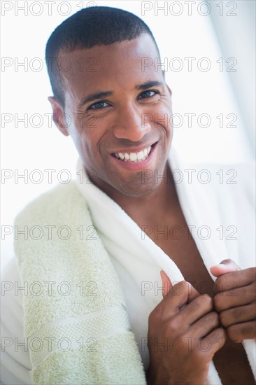 Portrait of young man in white bathrobe