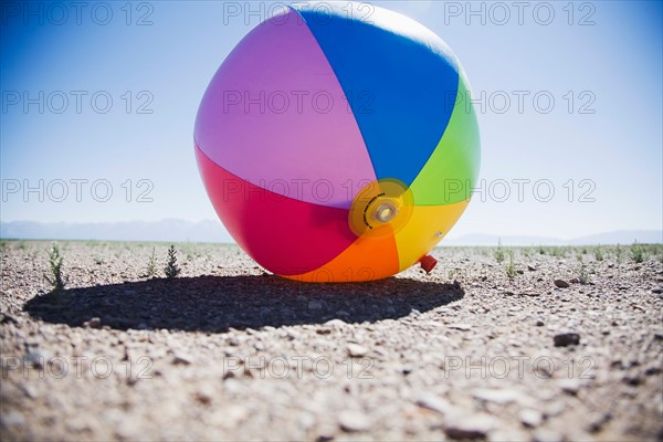 Beach ball in dry field