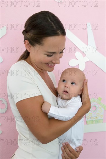 Mother holding baby daughter (6-11 months)