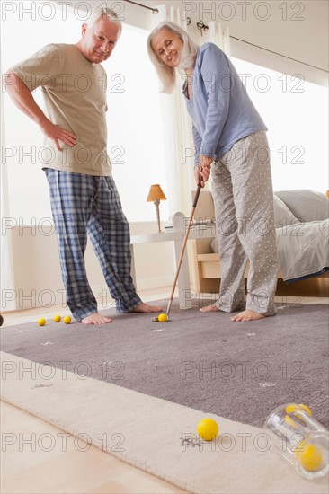 Senior couple playing mini golf at home. Photo: Rob Lewine