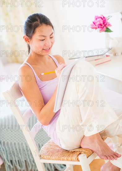 View of teenage girl ( 16-17 years) studying at home