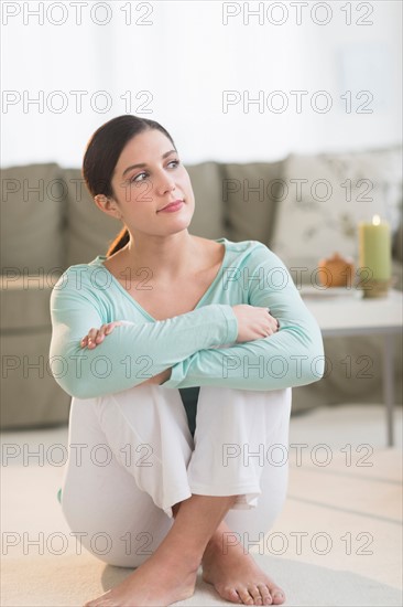 Woman sitting in living room.