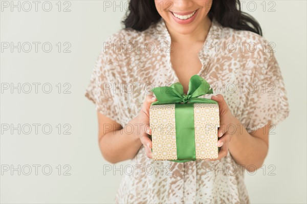 Young woman holding present.