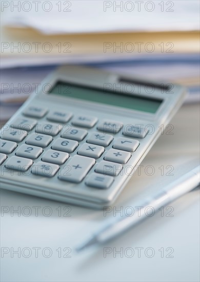 Studio Shot of calculator, pen and paper material