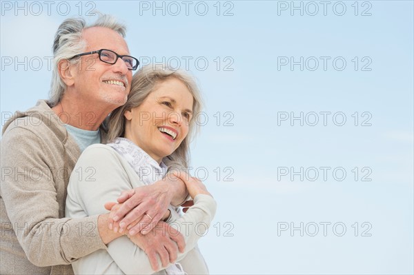 Senior couple embracing outdoors.