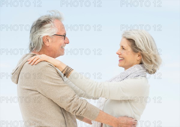 Senior couple embracing outdoors.