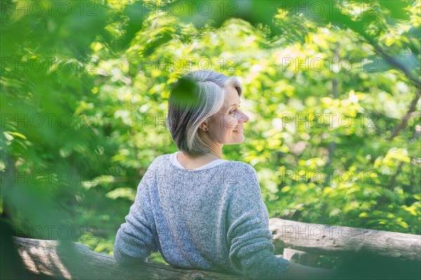 Central Park, New York City. Senior woman relaxing in park.