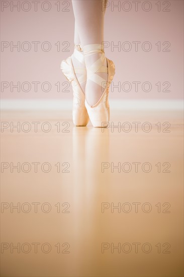 Low section of ballet dancer (16-17) tiptoing