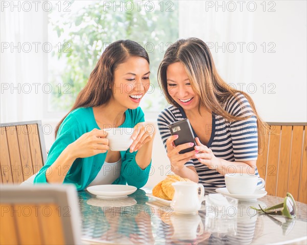 Two women using mobile phone