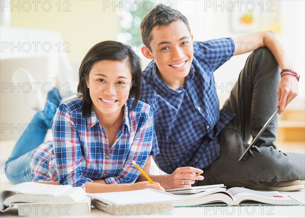 Portrait of young woman and young man learning