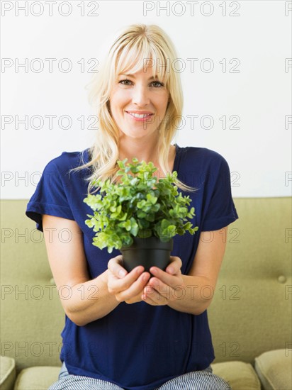 Woman holding potted plant