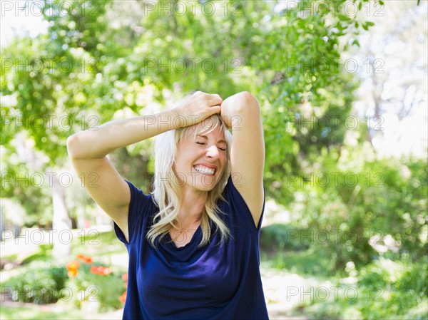 Portrait of blonde woman in park