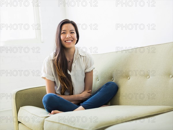 Portrait of woman sitting on sofa