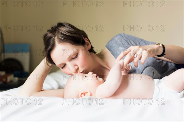 Mother kissing baby boy (2-5 months)