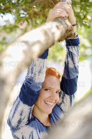 Portrait of woman holding branch.