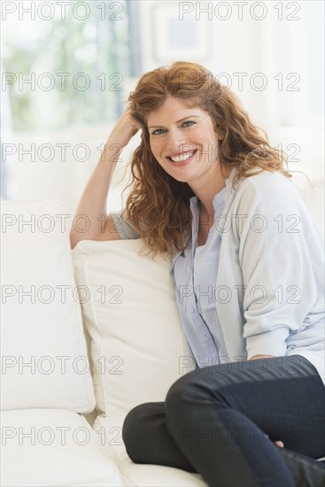 Woman sitting on sofa.