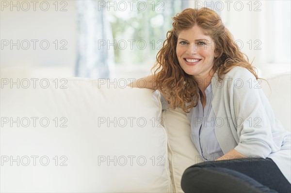 Woman sitting on sofa.