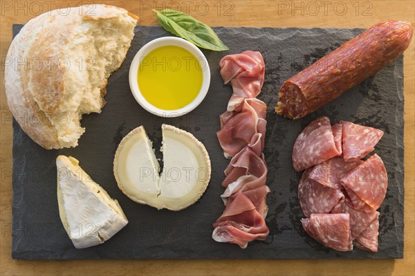 Studio shot of cheese, meat and bread on pate