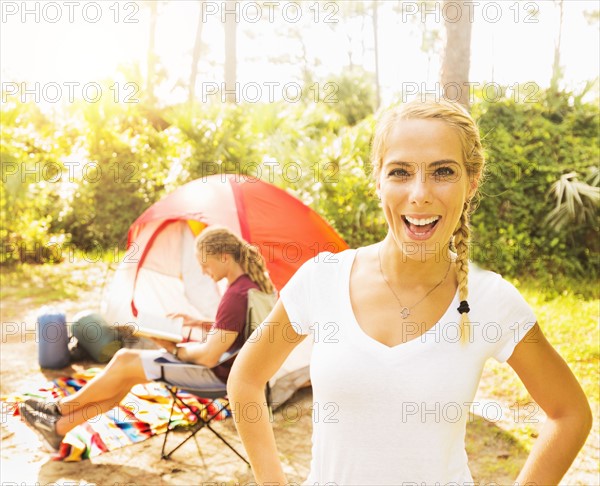 Portrait of smiling woman and man reading book