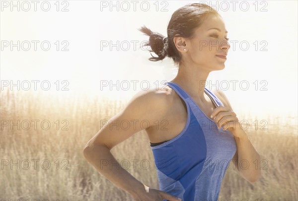 Young woman running outdoors.