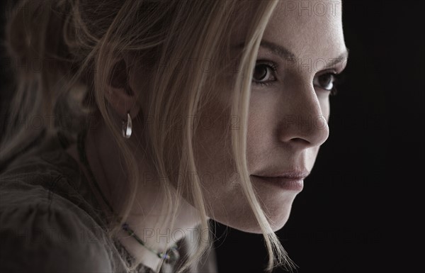 Portrait of blond woman in studio.