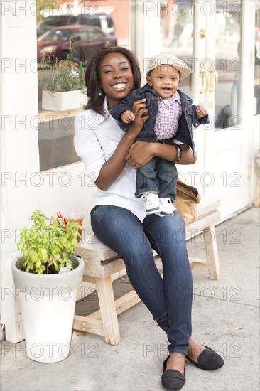 Portrait of smiling woman holding son (12-17 months)