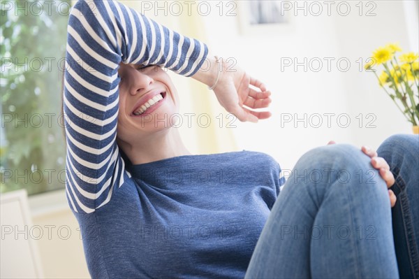 Woman shielding her eyes and laughing