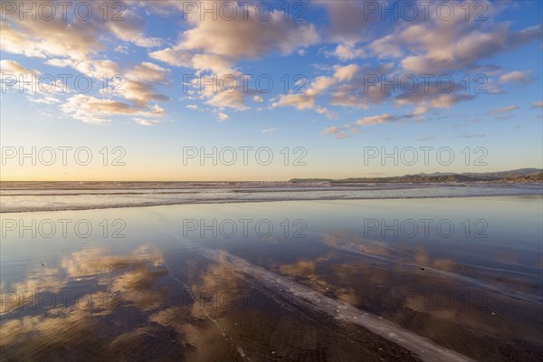 Cloudy sky reflected in sea