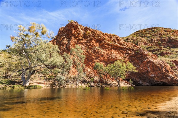 Australia, Outback, Northern Territory, Red Centre, West Macdonnel Ranges, Ormiston Gorge, Orange colored lake in red rock mountains