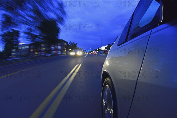 USA, Colorado, Denver, Car on city street at dusk